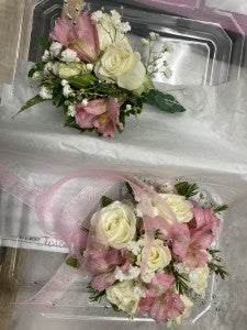 White and pink wrist corsage and boutonniere