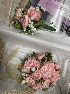 Pink wrist corsage and boutonniere
