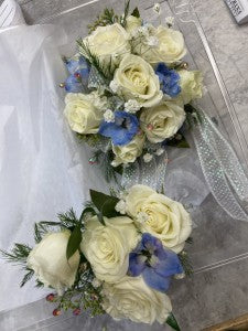 White and blue wrist corsage and Boutonniere
